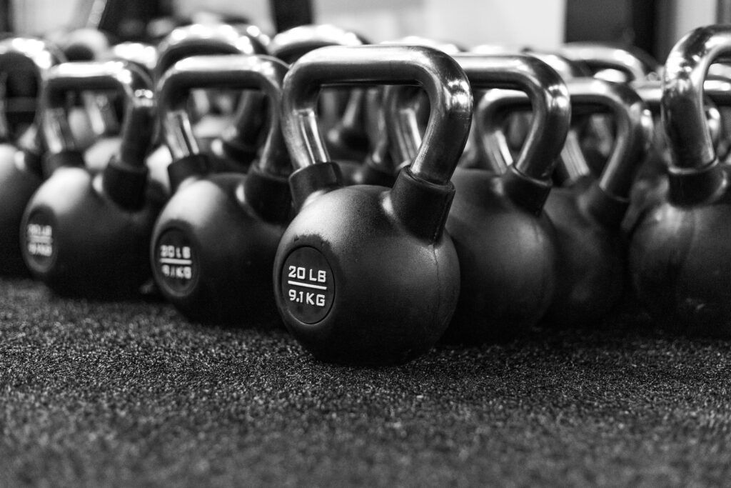 Multiple Kettlebells laid out in a row next to each otehr